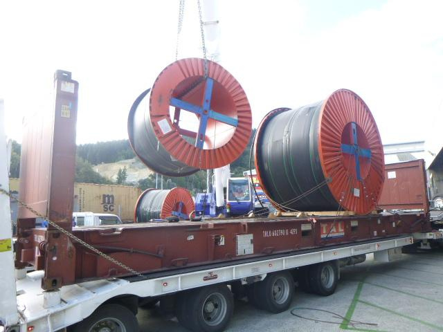 The large cables being loaded onto a flat rack