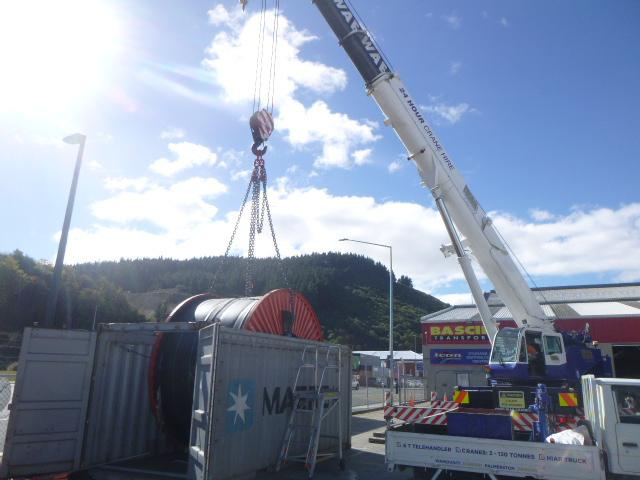 The crane placing the cable into a container